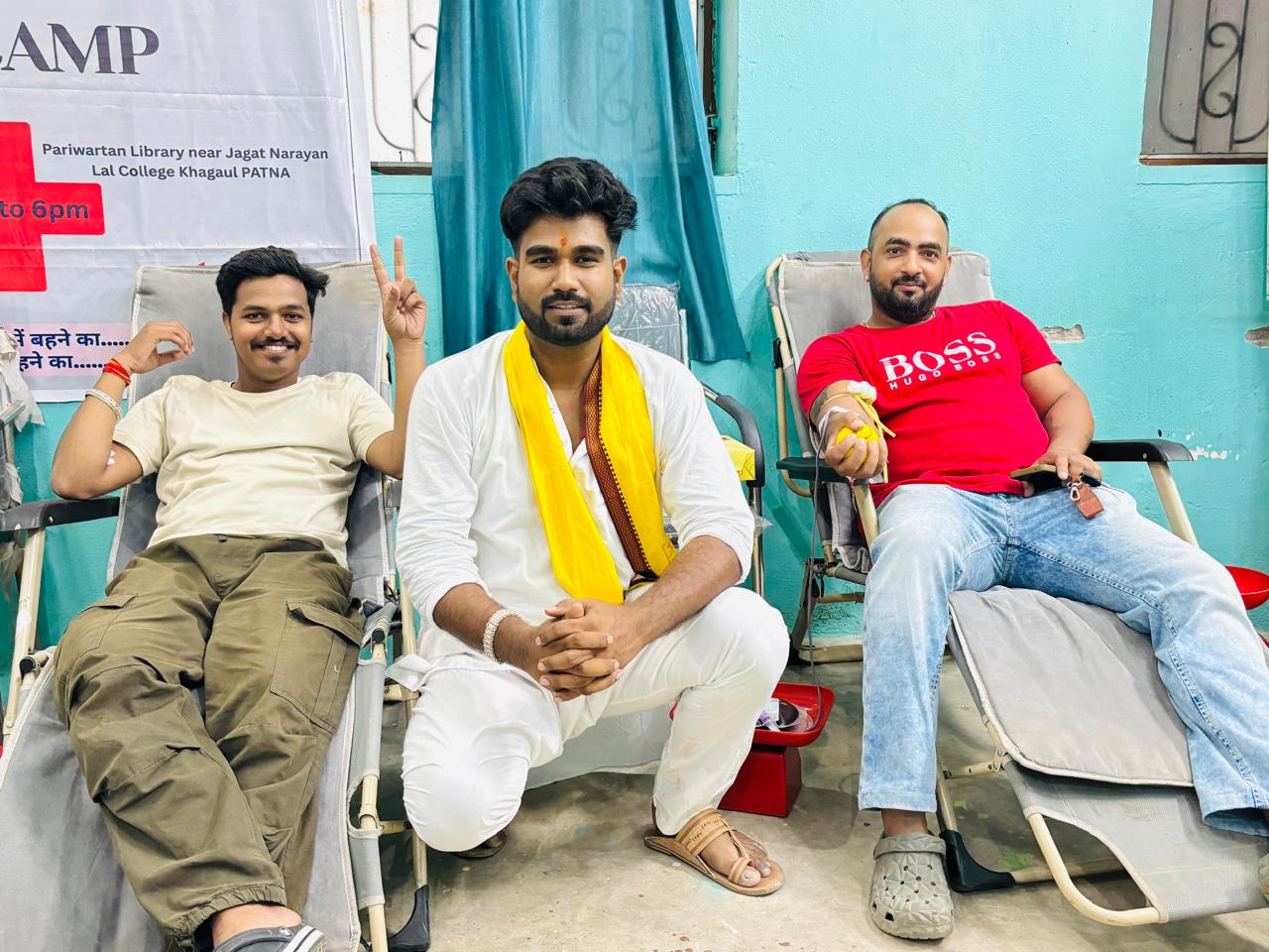 Donors and a volunteer at the Mega Blood Donation Camp