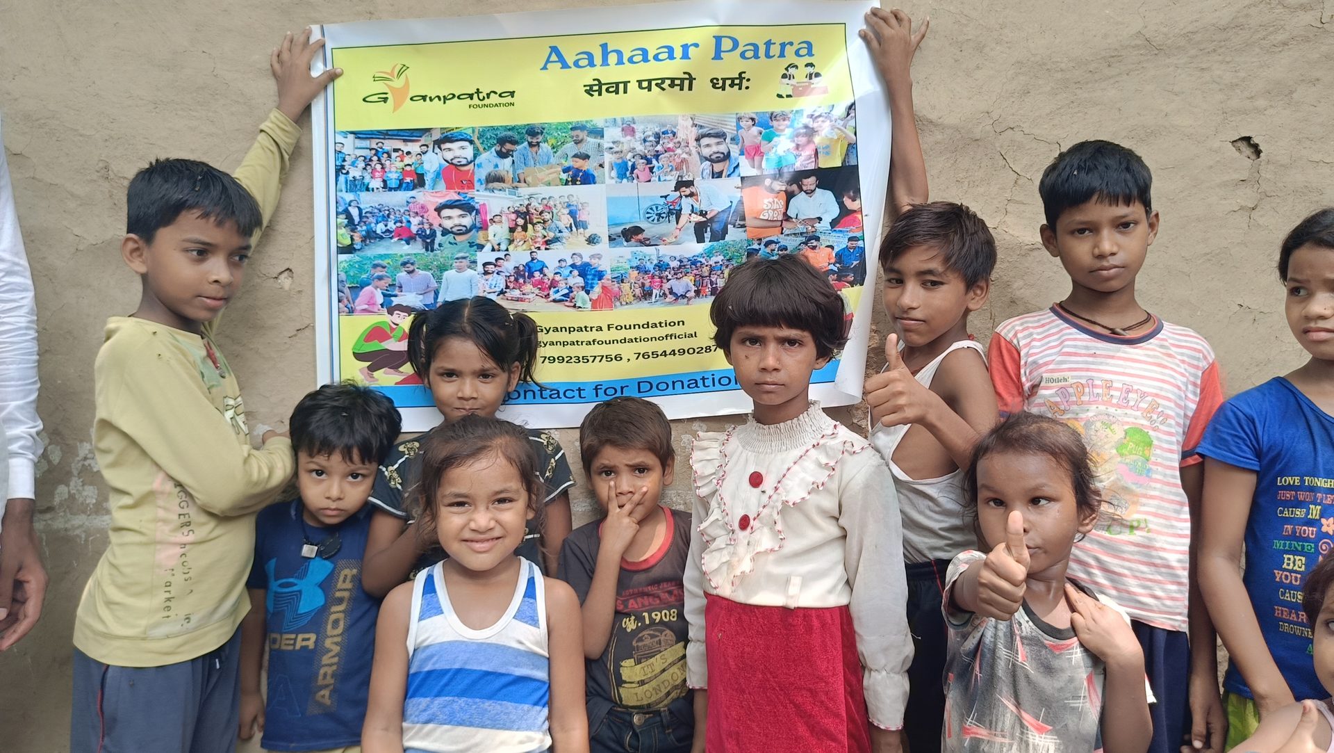 Children holding the Aahaar Patra banner