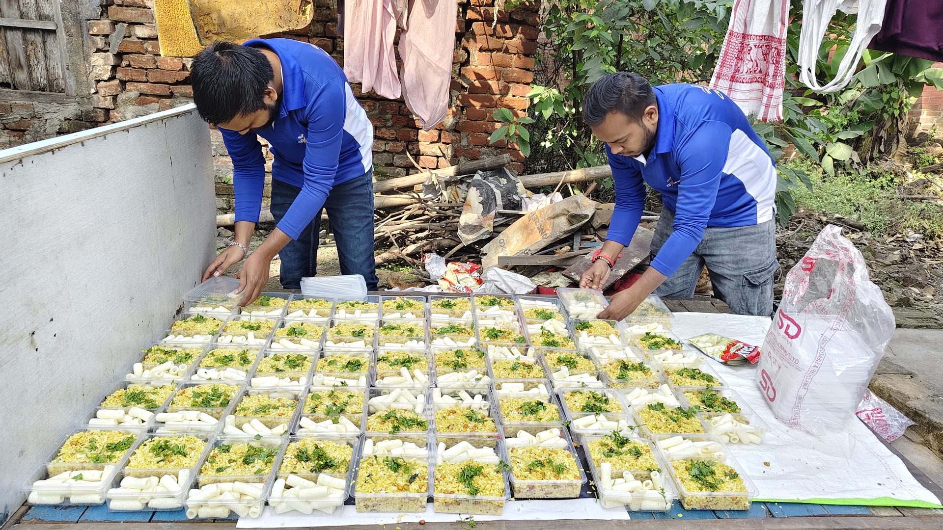 Volunteers packing meal boxes for distribution
