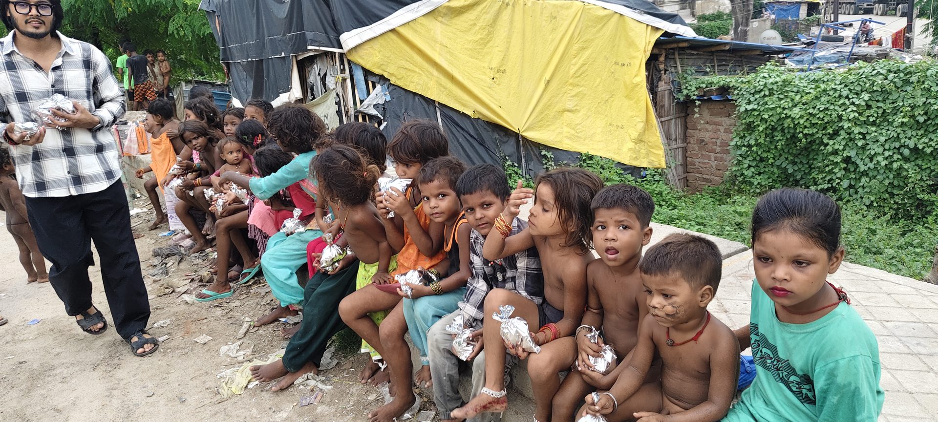 Children with meal packets after a distribution